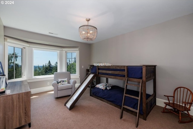 carpeted bedroom with a chandelier