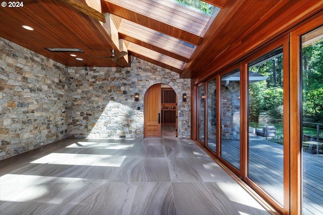 interior space featuring vaulted ceiling with beams and wooden ceiling