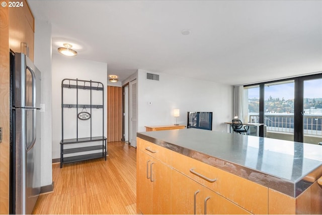 255 SW Harrison St Unit 21C, Portland, OR 97201 - kitchen with freestanding refrigerator and light wood-style flooring