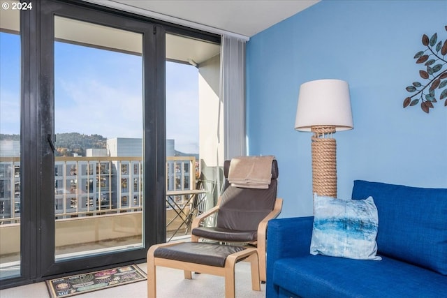 sitting room with carpet flooring and expansive windows