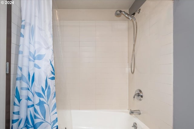 bathroom with shower / bath combination with curtain