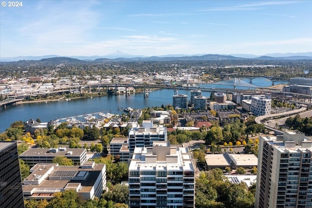 drone / aerial view featuring a water and mountain view