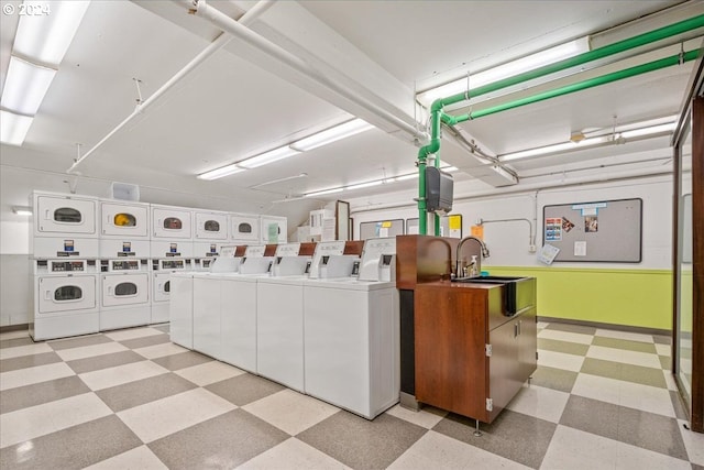 255 SW Harrison St Unit 21C, Portland, OR 97201 - communal laundry room featuring independent washer and dryer, light flooring, baseboards, and stacked washer and clothes dryer
