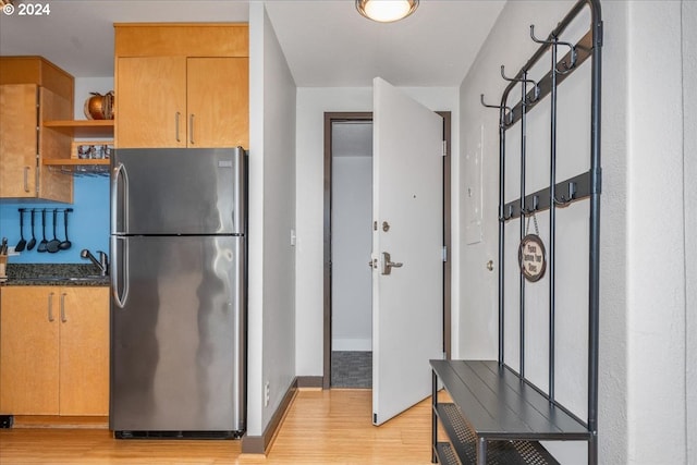 255 SW Harrison St Unit 21C, Portland, OR 97201 - kitchen featuring freestanding refrigerator, light wood-type flooring, open shelves, and a sink