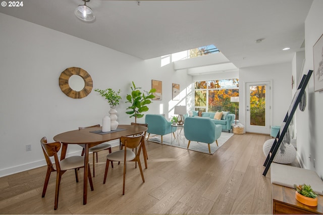 dining space with light hardwood / wood-style floors