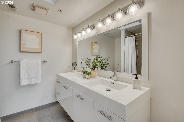 bathroom featuring vanity and a textured ceiling