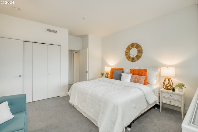 bedroom featuring light carpet and a closet