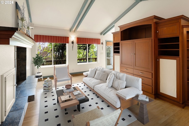 living room featuring vaulted ceiling with beams and light hardwood / wood-style flooring