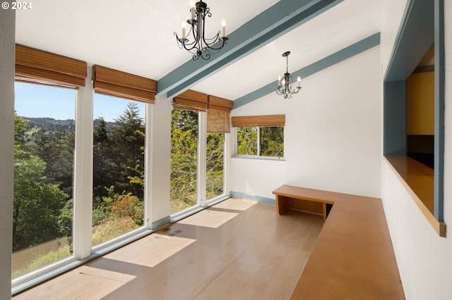 unfurnished sunroom featuring lofted ceiling with beams and a notable chandelier