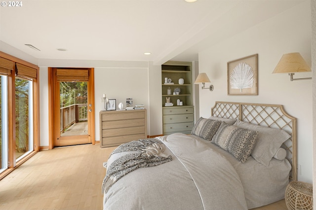 bedroom with access to exterior and light hardwood / wood-style floors