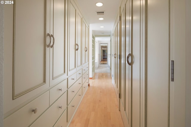 hallway with light hardwood / wood-style floors