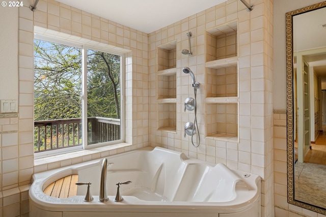 bathroom with tile walls and a bathtub