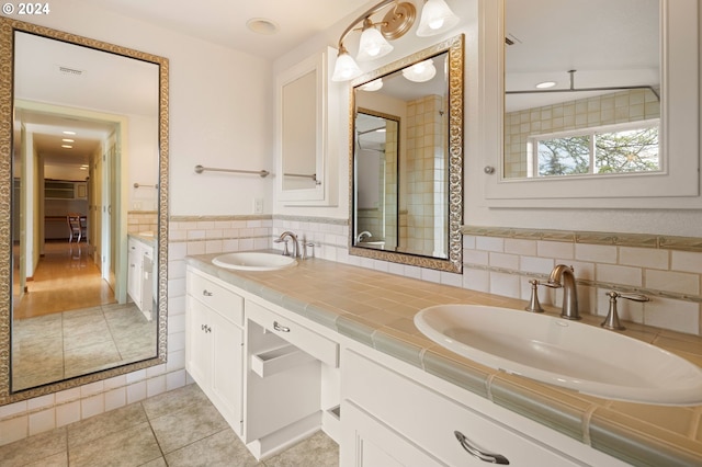 bathroom featuring tile patterned floors, tile walls, and vanity