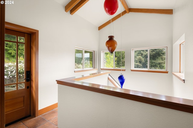 kitchen featuring vaulted ceiling with beams, pendant lighting, and light tile patterned floors