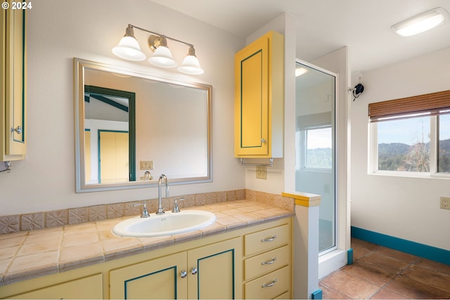 bathroom featuring tile patterned flooring, vanity, and an enclosed shower