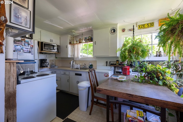 kitchen with white cabinetry, white range with electric stovetop, sink, and light tile floors