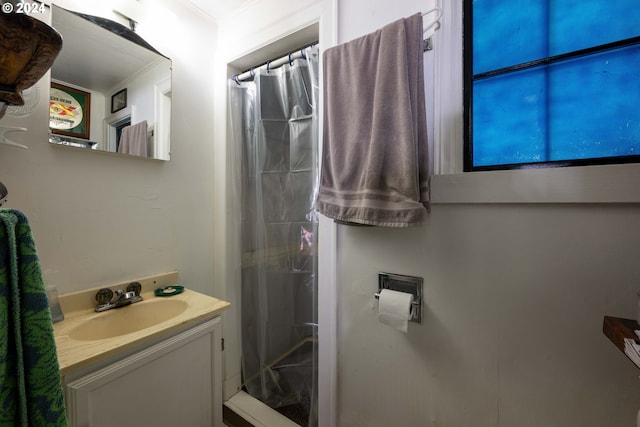 bathroom featuring a shower with curtain, crown molding, and vanity