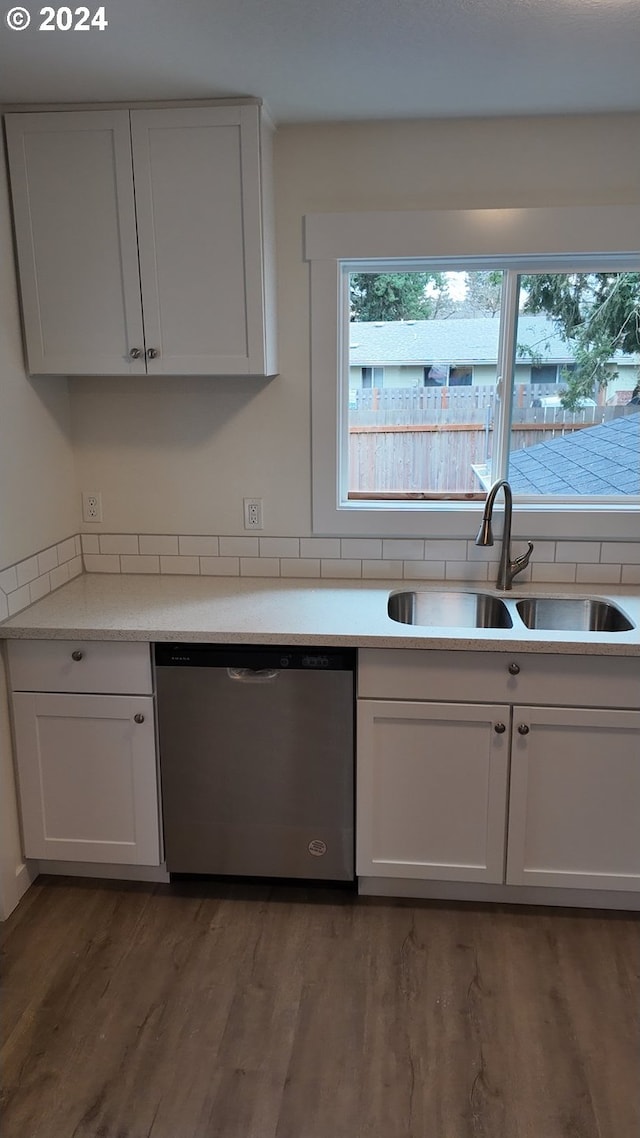 kitchen with wood-type flooring, white cabinetry, dishwasher, and sink