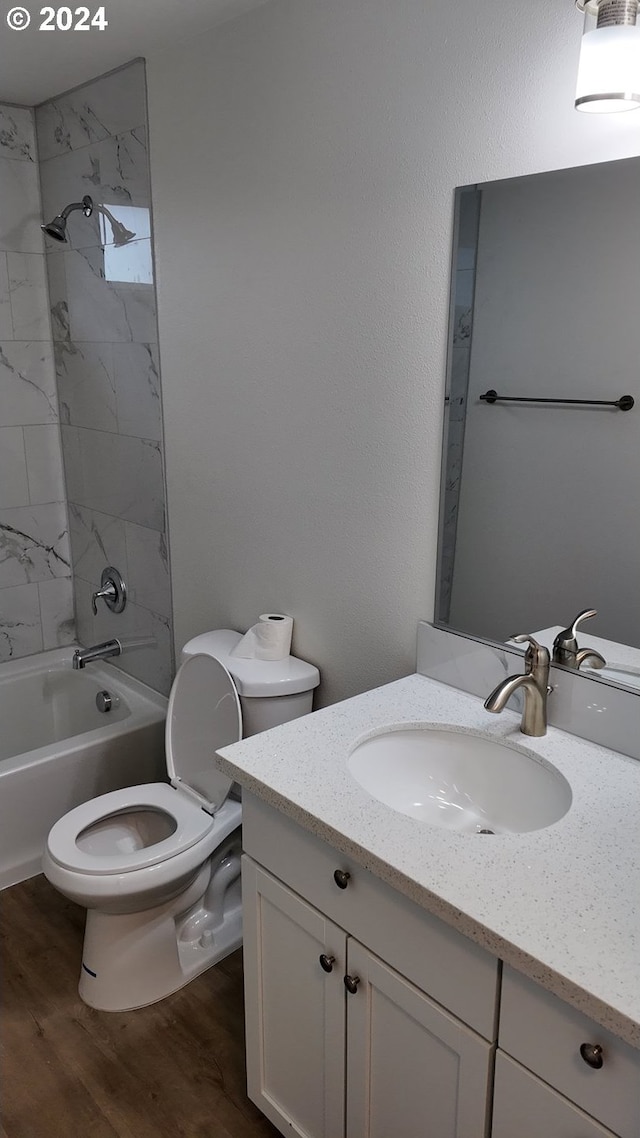 full bathroom with wood-type flooring, shower / bathtub combination, vanity, and toilet