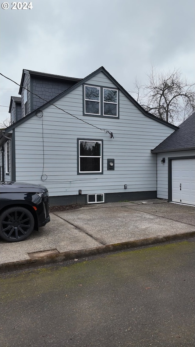 view of side of property with a garage