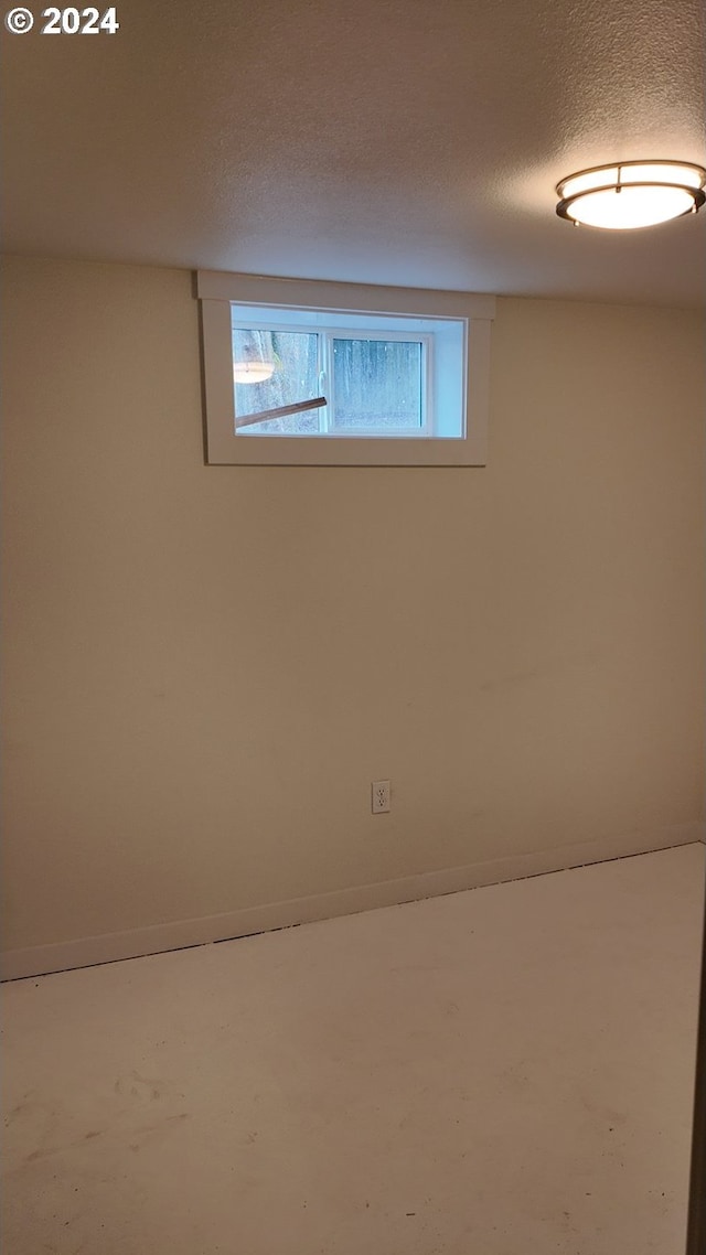 basement featuring a textured ceiling