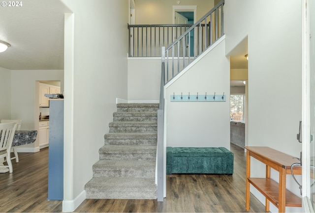 stairs with baseboards and wood finished floors