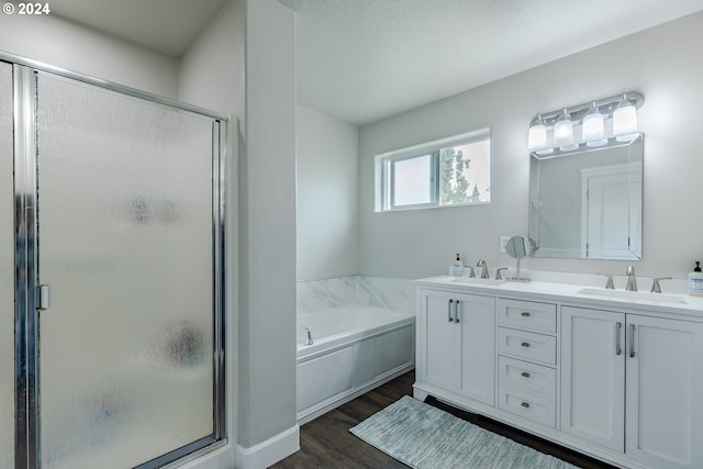 bathroom featuring vanity, separate shower and tub, and wood-type flooring