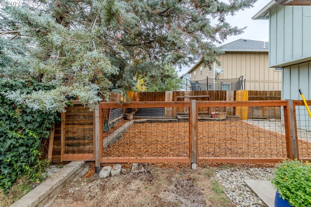 view of gate with a fenced backyard