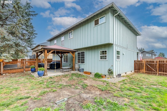 rear view of house featuring a patio, a gazebo, and a yard