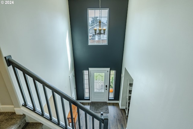 entrance foyer with an inviting chandelier, a high ceiling, and dark hardwood / wood-style flooring