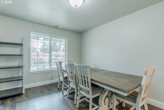 dining room with dark hardwood / wood-style floors