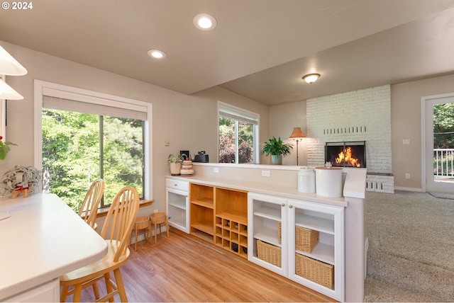 kitchen featuring a fireplace and wood-type flooring