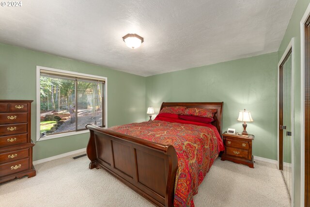 carpeted bedroom with a textured ceiling