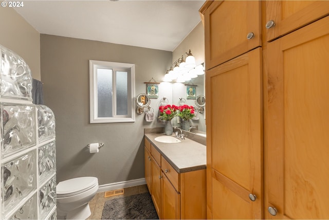 bathroom featuring tile patterned floors, vanity, and toilet