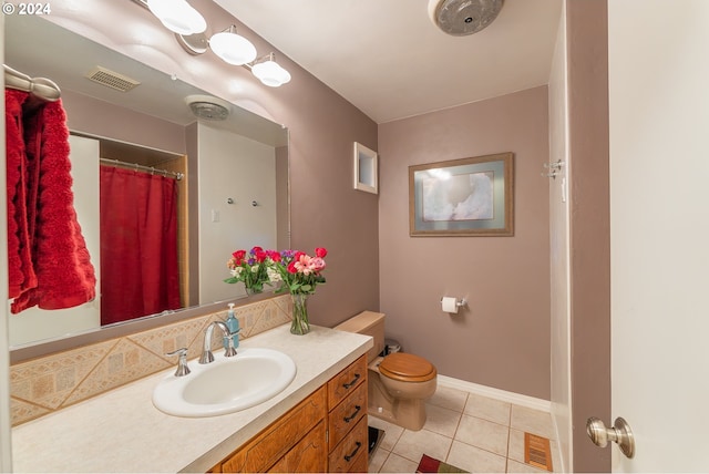 bathroom with tile patterned floors, vanity, and toilet