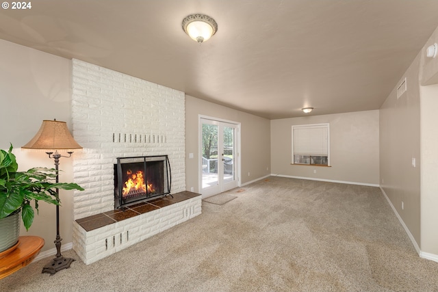 unfurnished living room featuring a fireplace and carpet