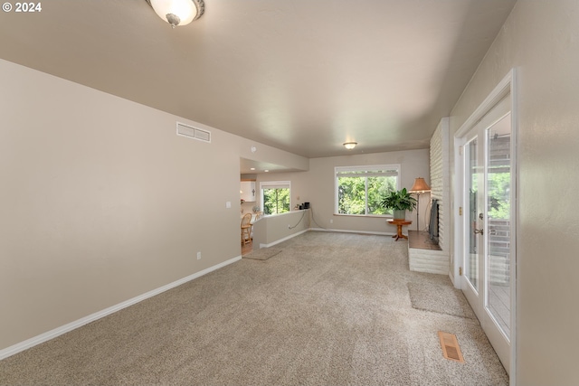 unfurnished living room with light carpet