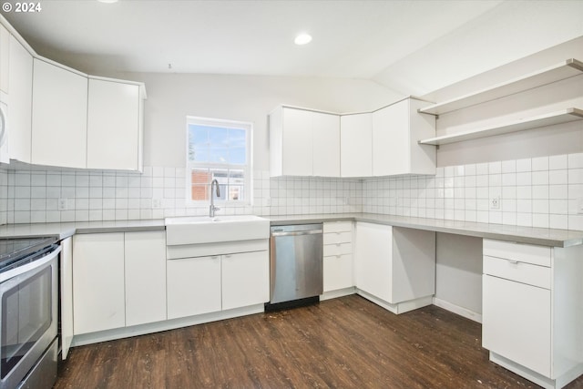 kitchen featuring appliances with stainless steel finishes, decorative backsplash, white cabinets, dark wood-type flooring, and lofted ceiling