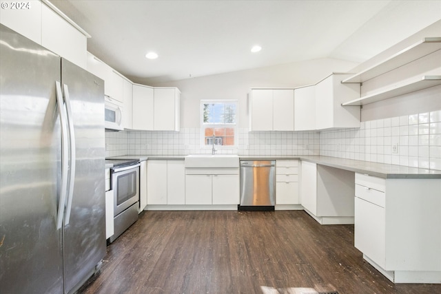 kitchen with white cabinets, appliances with stainless steel finishes, dark wood-type flooring, and backsplash