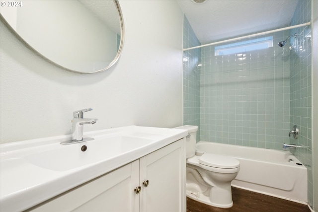 full bathroom with wood-type flooring, toilet, vanity, and tiled shower / bath