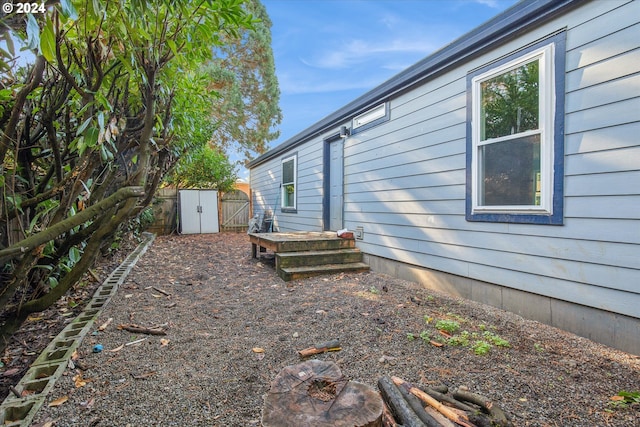 view of side of home with a storage unit