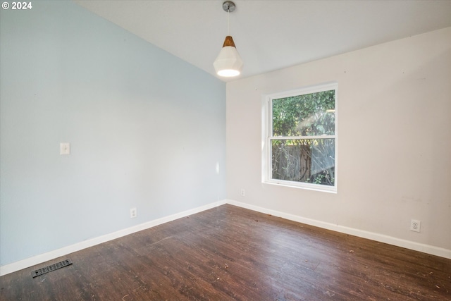 spare room featuring dark wood-type flooring