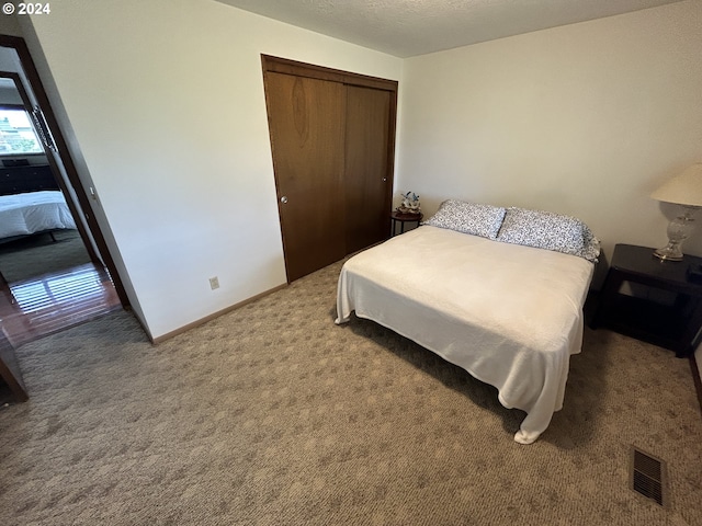 carpeted bedroom with a closet