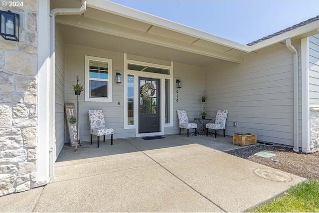 entrance to property featuring a patio area