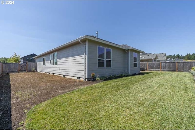 view of side of property with a lawn