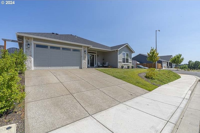 single story home featuring a front yard and a garage