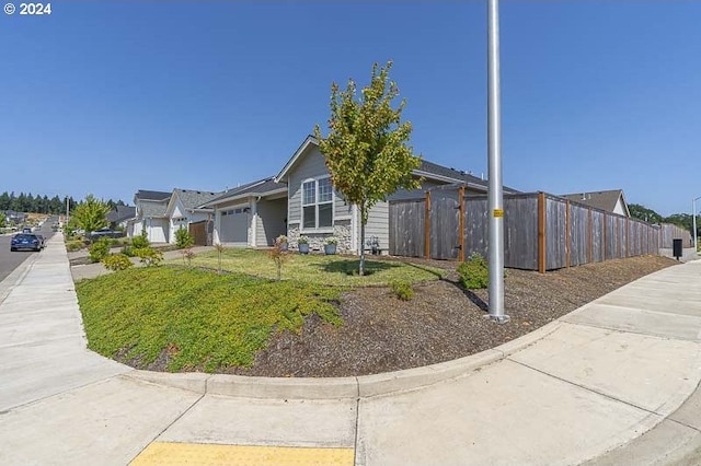 view of front of property with a front yard and a garage