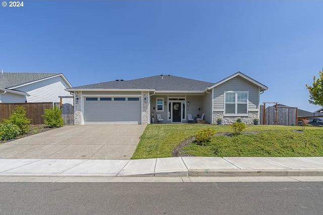 view of front of house featuring a front yard and a garage