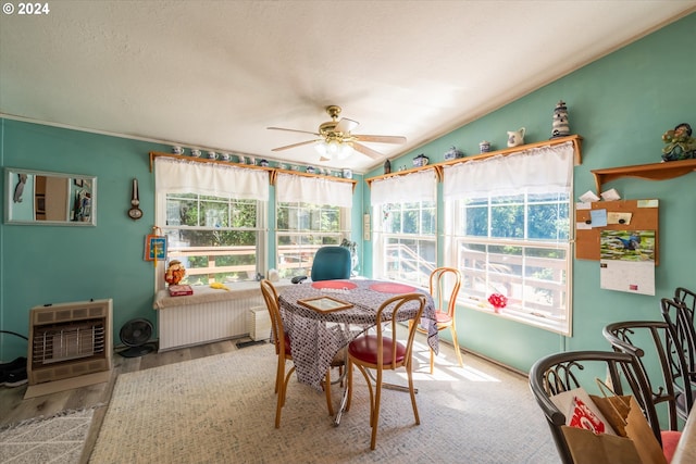 sunroom featuring heating unit, radiator heating unit, ceiling fan, and vaulted ceiling