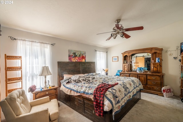 bedroom featuring multiple windows, light colored carpet, and ceiling fan